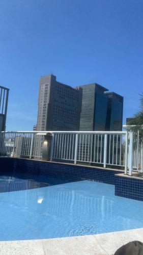 a large swimming pool with buildings in the background at Apartamento no coração do Rio in Rio de Janeiro