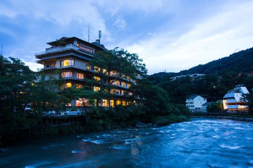 a building on the side of a river at Hakone Yumoto Onsen Hotel Kajikaso in Hakone