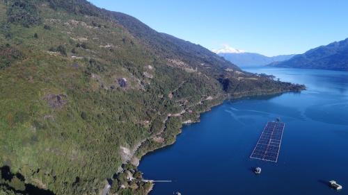 an island in the middle of a body of water at Cabañas Loft Alto Arrayan Cochamó in Cochamó