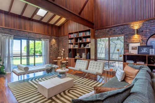 a living room with a couch and a table at Summer of 81 I Private Properties in Vasse