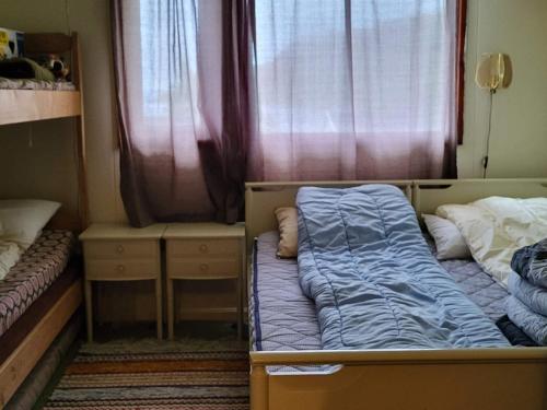 a small bedroom with a bed and a window at Holiday home Reinfjord in Spildra