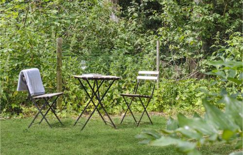 two chairs and a table in the grass at Stunning Home In Stokkemarke With Wifi in Stokkemarke