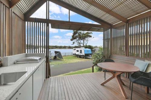 a kitchen with a table and a view of a rv at Reflections Shaws Bay - Holiday Park in Ballina