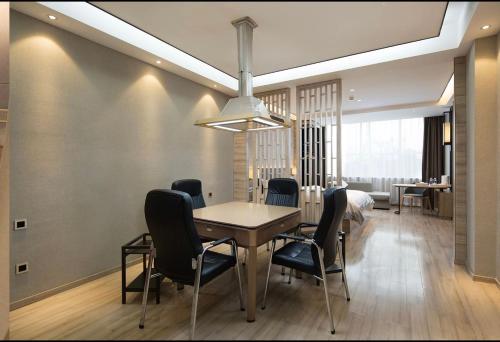 a dining room with a table and chairs at Morning Hotel, Wuhan Jinyin Lake Garden Expo Garden Yuya Yinhu City in Dongxihu