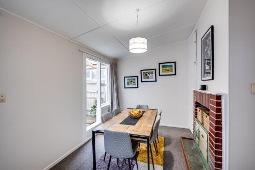 a dining room with a table and chairs at Central Cottage - Napier Holiday Home in Napier
