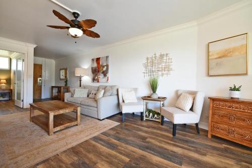 a living room with a couch and a ceiling fan at Hale Ono Loa 203 in Kahana