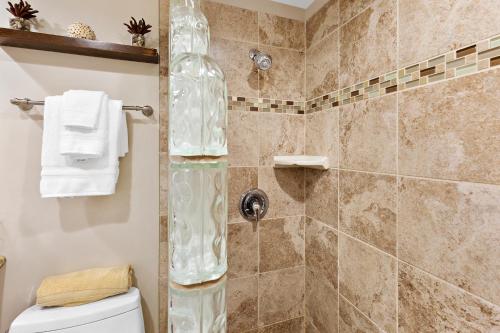 a bathroom with a shower with a toilet at Maalaea Banyans 314 in Wailuku