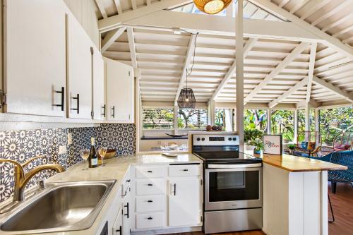 a kitchen with a sink and a stove at International Colony 17 in Lahaina
