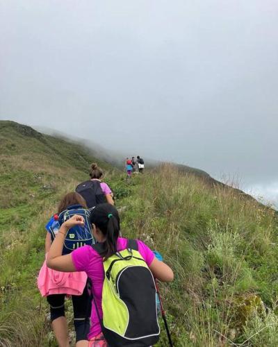 a group of people walking up a hill with backpacks at Complejo de Cabañas Eco-sustentables - La escondida - in San Salvador de Jujuy