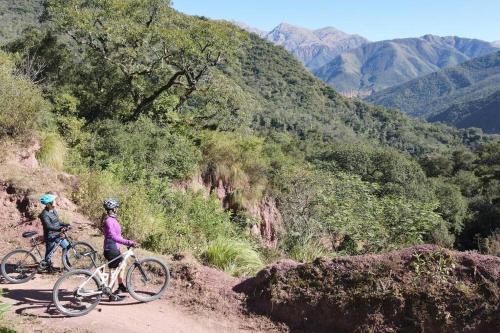 two people riding bikes on a dirt road at Complejo de Cabañas Eco-sustentables - La escondida - in San Salvador de Jujuy