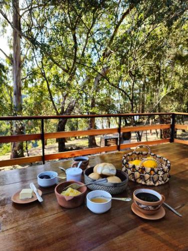 a table with bowls of food on a wooden table at Complejo de Cabañas Eco-sustentables - La escondida - in San Salvador de Jujuy