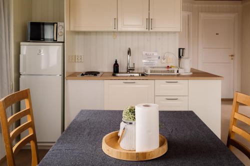 a kitchen with a table with a roll of paper towels at Guesthouse Brekka in Brekka