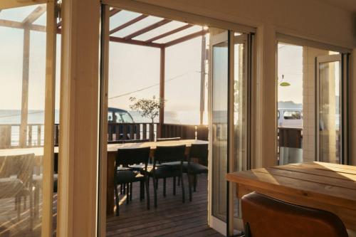 a dining room with a table and a view of the ocean at Zaimokuza SOLA 鎌倉材木座 in Kamakura