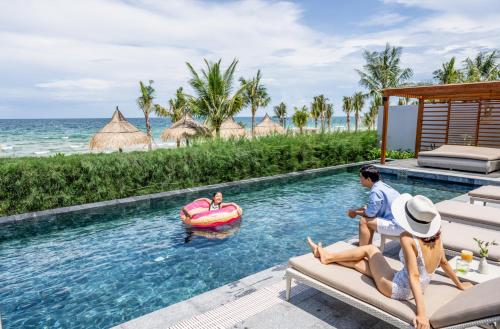 a group of people in a pool at a resort at Crowne Plaza Phu Quoc Starbay by IHG in Phu Quoc