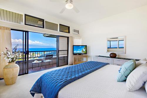 a bedroom with a bed and a view of the ocean at Kapalua Ridge Villa 2622 in Kahana