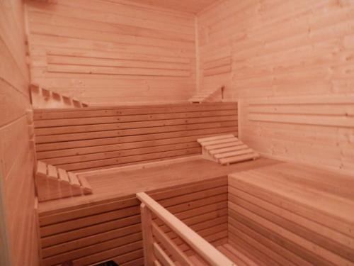 an empty sauna with wooden floors and stairs at Penzion Eden Turnov in Turnov