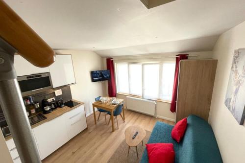 a small living room with a blue couch and a table at M8 Le vieux MassyRER600mOrly20 minNetflixNeuf in Massy