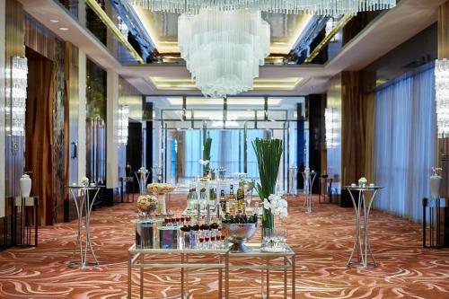 a lobby with a table with bottles of wine at Zhuzhou Marriott Hotel in Zhuzhou