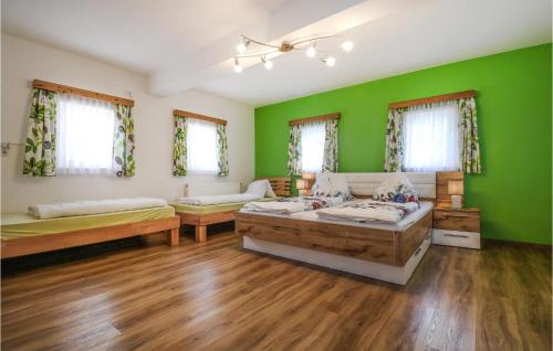 a green room with two beds and a couch at Awesome Home In Oberhaag With 1 Bedrooms in Oberhaag