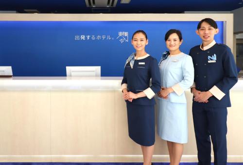 a group of three women standing in front of a counter at Toyoko Inn Osaka Taniyon Kosaten in Osaka