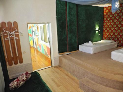 a room with a bed and a bathroom with a mirror at Art Hostel in Tashkent