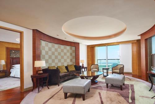 a living room with a couch and a table at Sheraton Zhoushan Hotel in Zhoushan