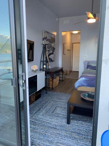 a room with a room with a bed and a table at Earls Cove Orca View in Egmont