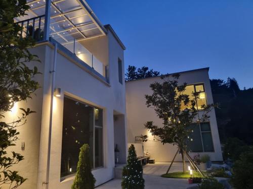 a white house with lights on it at night at Namhae Bay 591 in Namhae