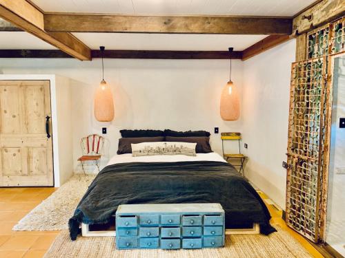 a bedroom with a large bed with blue boxes at Whitewater Byron Bay in Byron Bay