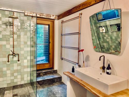 a bathroom with a sink and a shower at Whitewater Byron Bay in Byron Bay