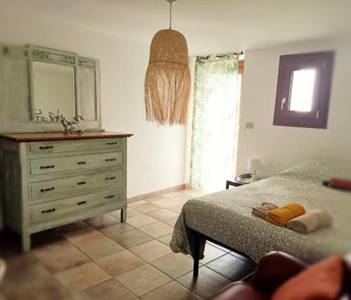 a bedroom with a bed and a dresser and a mirror at Amrita Rosa in Castellamonte