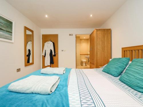 a bedroom with two beds with blue and white sheets at Rock Pool in Downderry