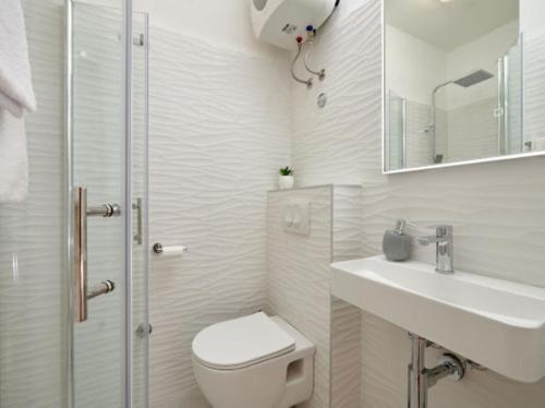 a bathroom with a toilet and a sink and a shower at Guesthouse Ana Trogir Old Town in Trogir