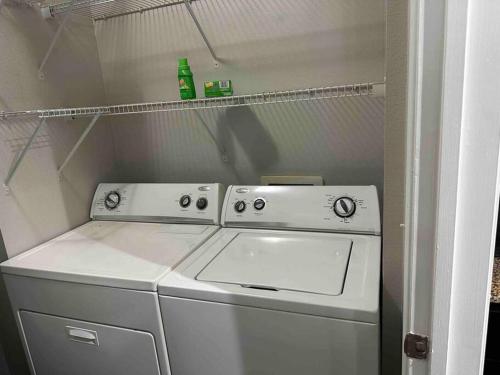 a washer and dryer in a small kitchen at Trendy, upscale apartment! in Houston