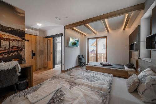 a bedroom with two beds and a balcony at Veldes B&B in Bled