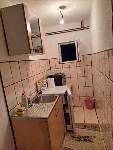 a small kitchen with a sink and a microwave at Ris in Foča