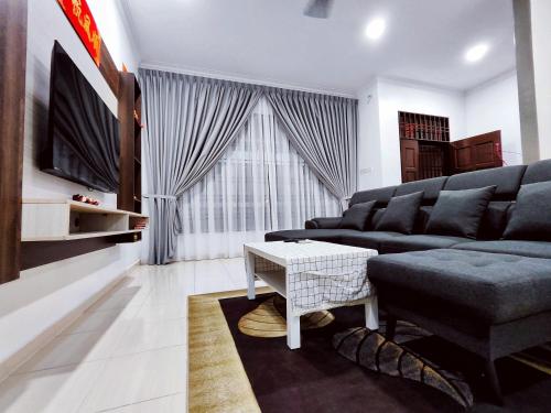 a living room with a couch and a table at TREX Homestay_Batu Pahat in Batu Pahat