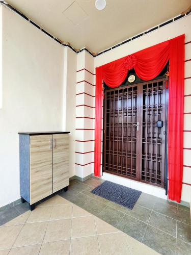 a room with a red curtain and a gate at TREX Homestay_Batu Pahat in Batu Pahat