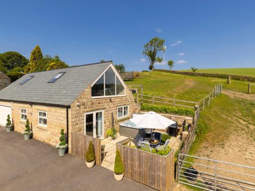 an aerial view of a house with a fence at Walton House Cottage in Chapel en le Frith