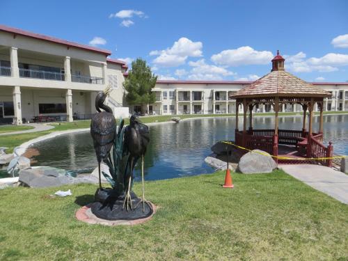 a statue of two birds standing next to a gazebo at Longstreet Inn & Casino in Amargosa Valley