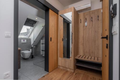 a bathroom with a toilet and a wooden door at Veldes B&B in Bled