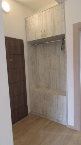 a room with a closet with wooden doors in it at Radgost Kotor Apartments in Kotor
