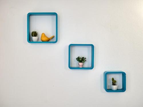 a wall with three blue plates with plants in them at Guesthouse Ana Trogir Old Town in Trogir