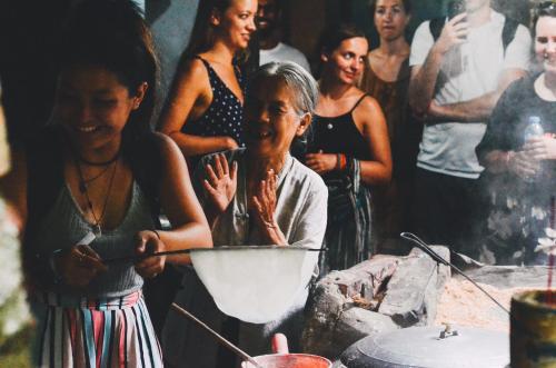 a group of people standing around a table at Hoianese Center Hotel - Truly Hoi An in Hoi An