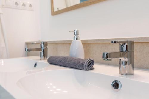a bathroom sink with a towel sitting on it at Bazalt Apartman in Badacsonytomaj