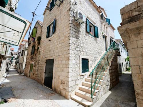 a brick building with stairs on the side of it at Guesthouse Ana Trogir Old Town in Trogir