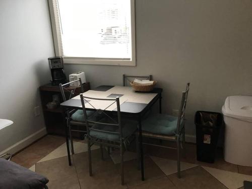 a table and chairs in a room with a window at Walk2Metro's,DCGem,Private,Wifi, FreeParking in Arlington