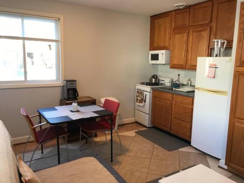 a kitchen with a table and a white refrigerator at Walk2Metro's,DCGem,Private,Wifi, FreeParking in Arlington