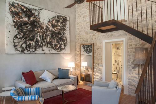 a living room with a couch and a staircase at Masseria Della Volpe in Casale Modica
