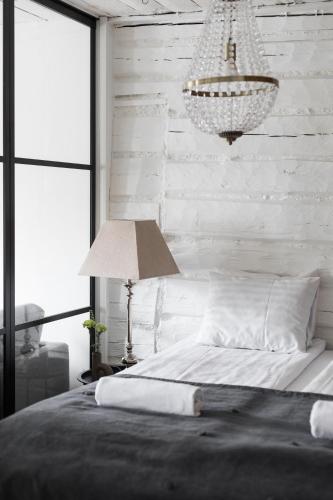 a bedroom with a bed and a chandelier at Bridget Inn in Naantali